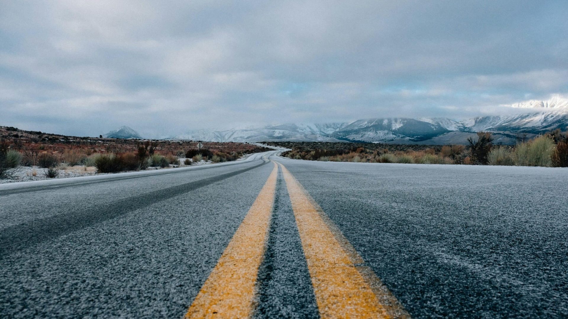 landscape photography of asphalt road under cloudy sky during daytime